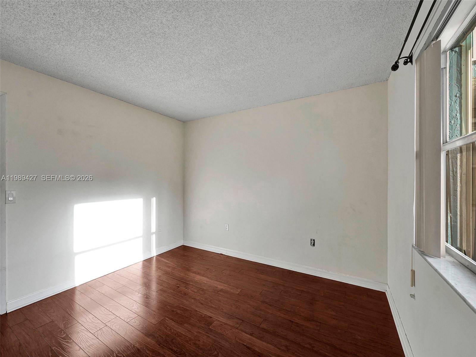 4600 Southwest 67th Avenue, Unit 155 Miami, FL 33155 - Photo 13 of 32 an empty room with wooden floor and windows