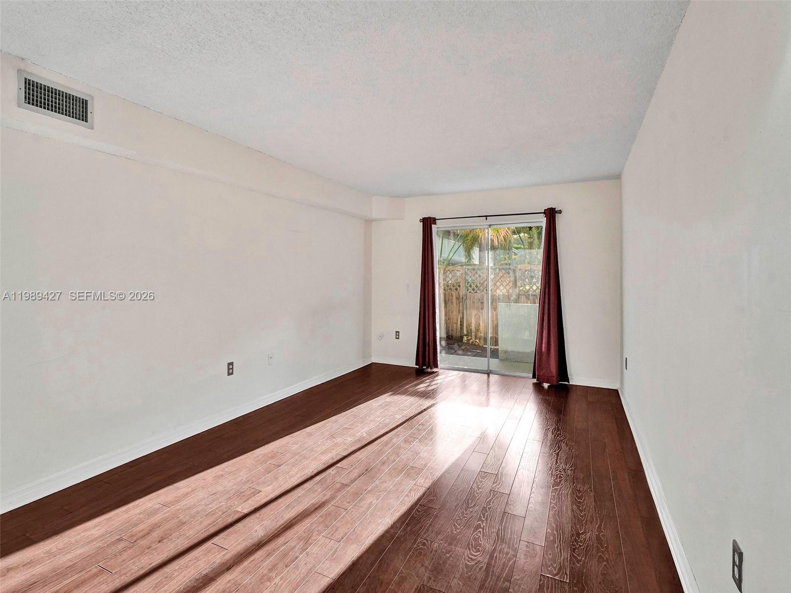 4600 Southwest 67th Avenue, Unit 155 Miami, FL 33155 - Photo 14 of 32 an empty room with wooden floor and windows