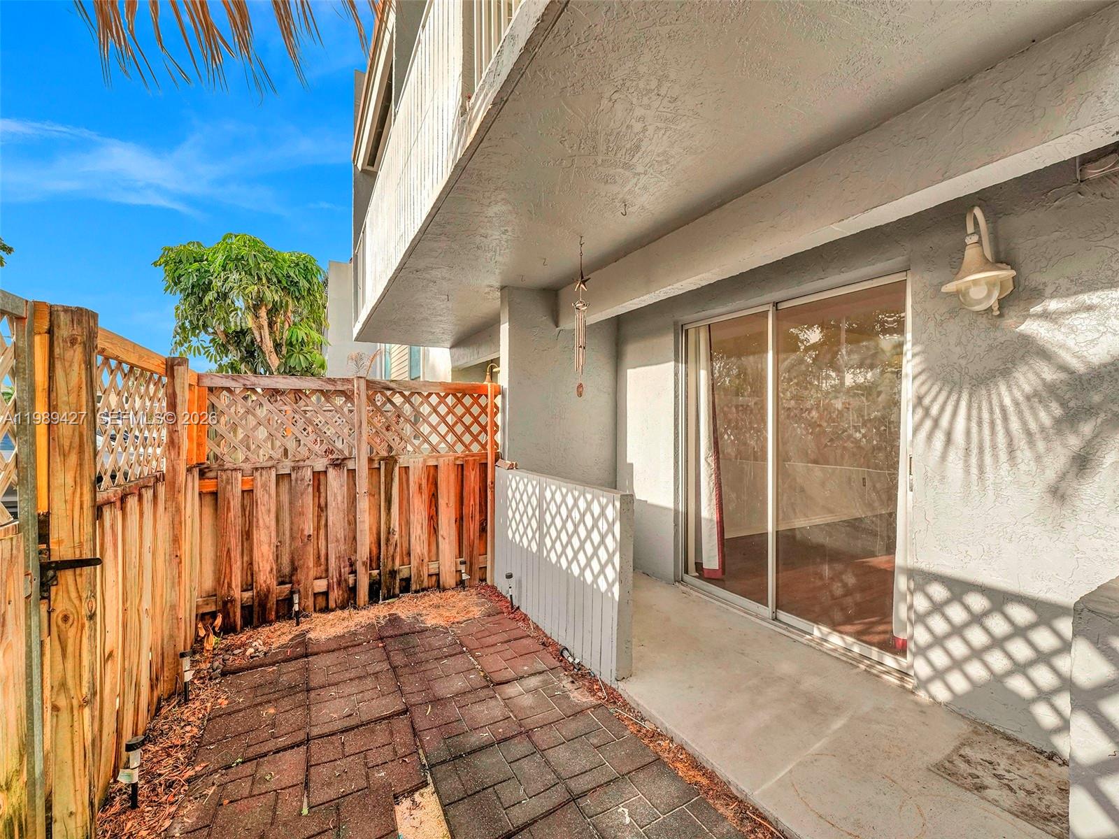 4600 Southwest 67th Avenue, Unit 155 Miami, FL 33155 - Photo 18 of 32 a view of a porch with a table and chair and floor to ceiling window