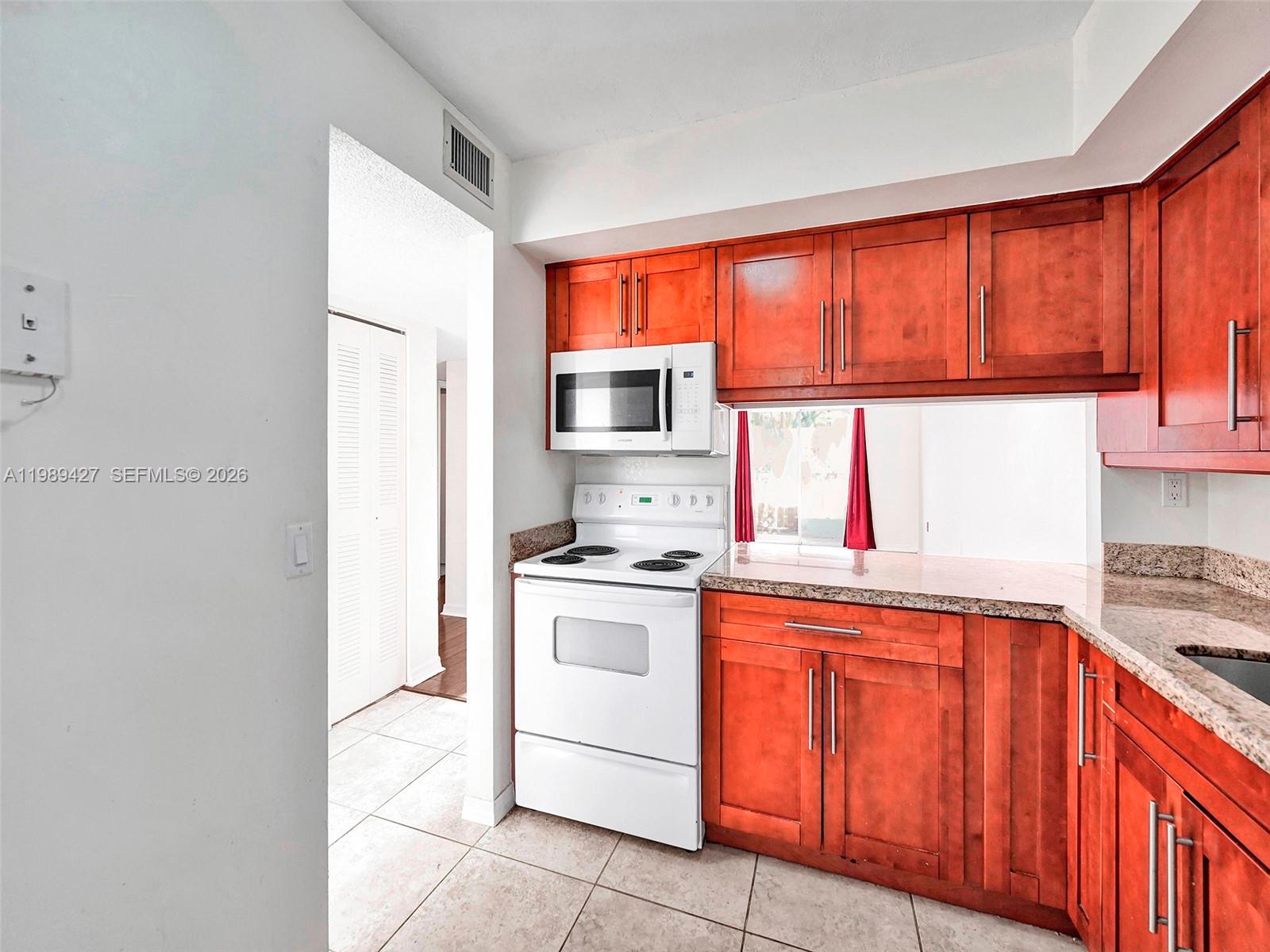 4600 Southwest 67th Avenue, Unit 155 Miami, FL 33155 - Photo 23 of 32 a kitchen with stainless steel appliances granite countertop a stove a sink and a microwave
