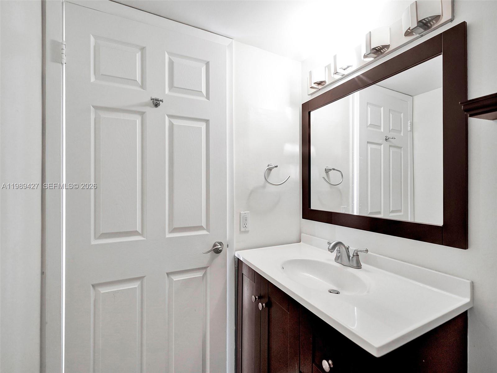 4600 Southwest 67th Avenue, Unit 155 Miami, FL 33155 - Photo 7 of 32 a bathroom with a sink and a mirror