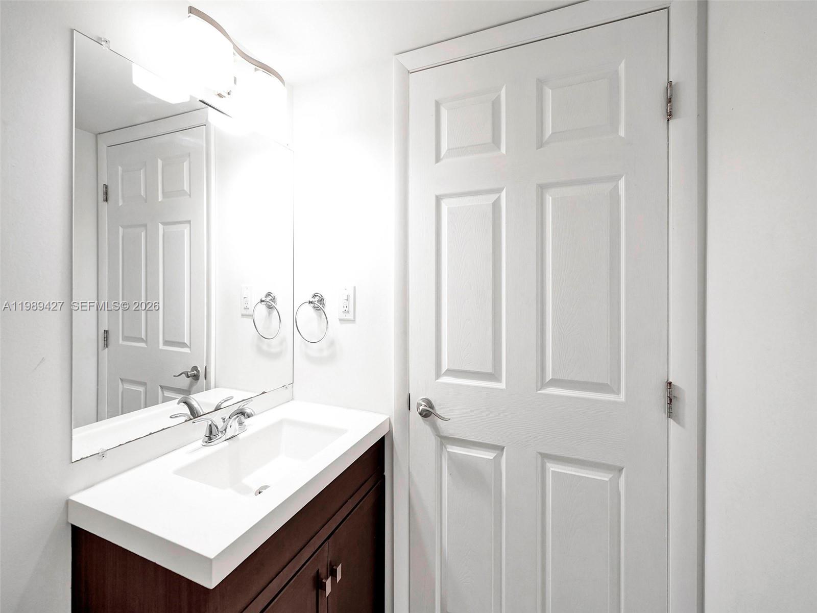 4600 Southwest 67th Avenue, Unit 155 Miami, FL 33155 - Photo 8 of 32 a bathroom with a sink vanity and a mirror