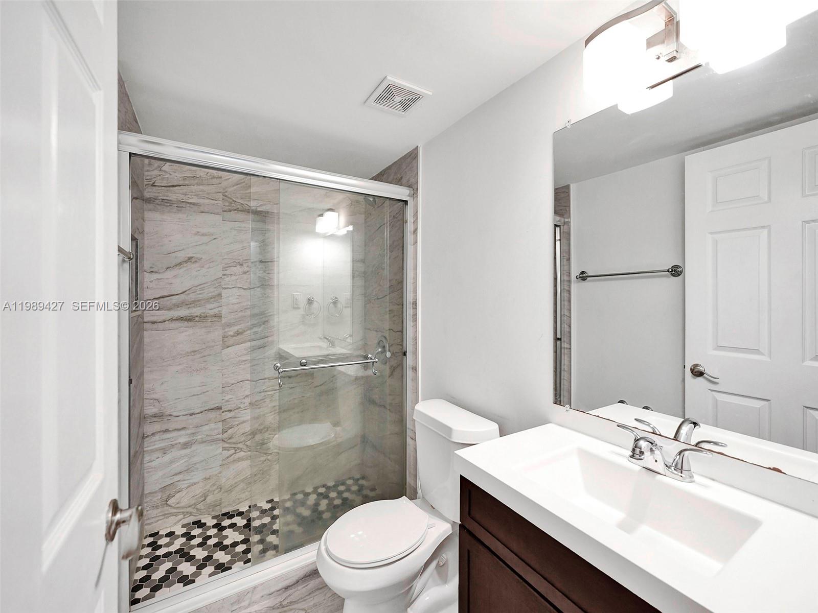 4600 Southwest 67th Avenue, Unit 155 Miami, FL 33155 - Photo 9 of 32 a bathroom with a sink a toilet and shower