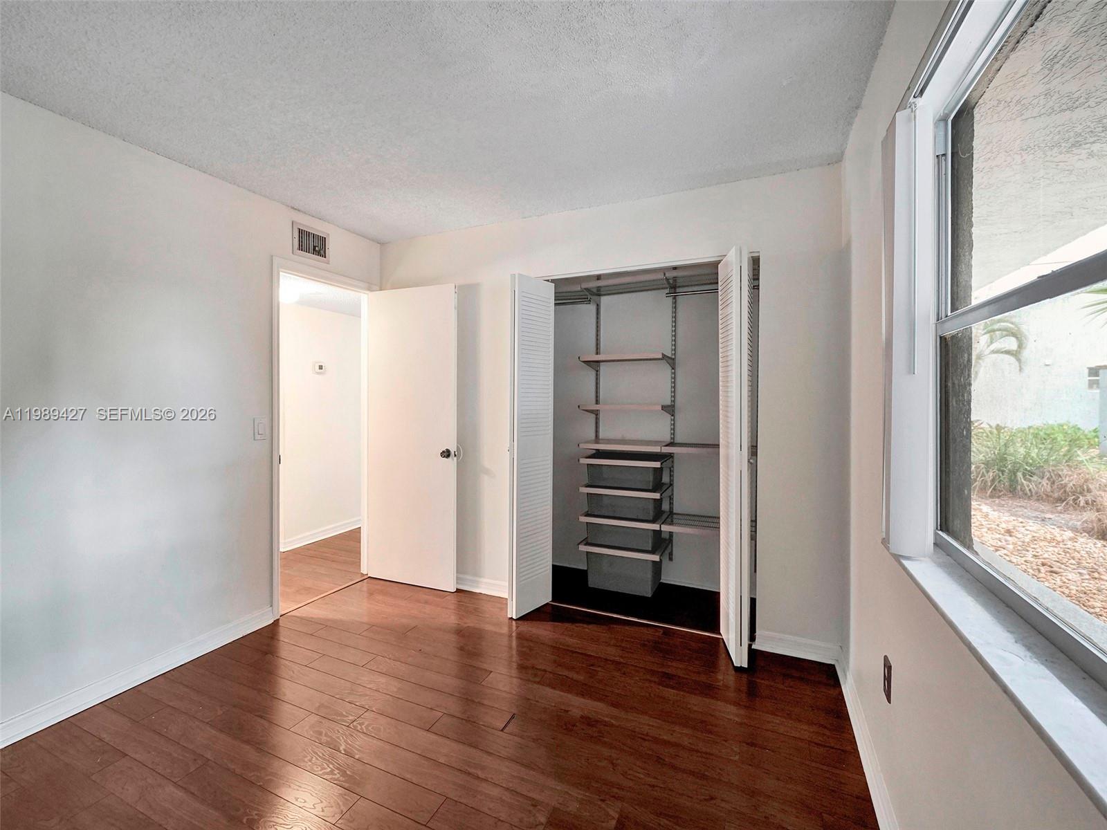 4600 Southwest 67th Avenue, Unit 155 Miami, FL 33155 - Photo 10 of 32 wooden floor in an empty room with a window