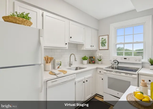 a kitchen with a sink cabinets and window