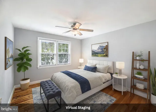 a bedroom with a bed and a potted plant
