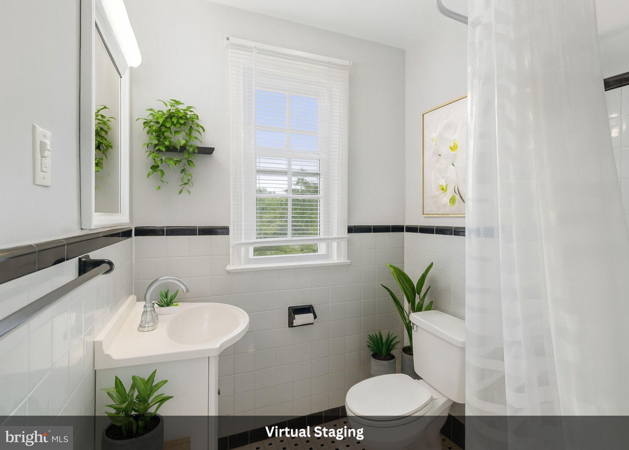2904 13th Road South, Unit 301 Arlington, VA 22204 - Photo 7 of 13 a bathroom with a sink a toilet and a mirror
