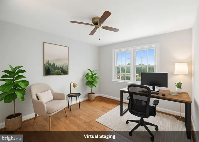a work room with furniture and a potted plant