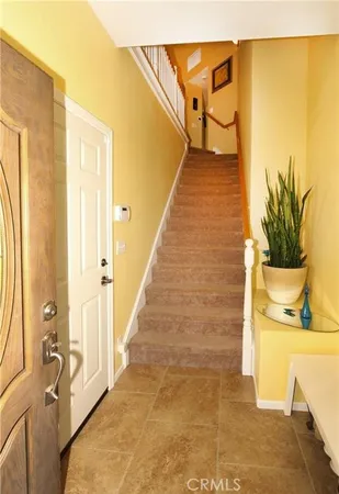 a living room with furniture a flat screen tv and a large window