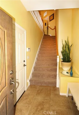 a living room with furniture a flat screen tv and a large window