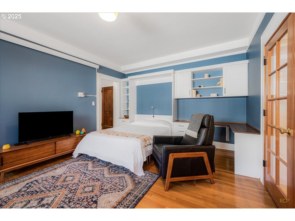 2015 Northwest Flanders Street, Unit 408 Portland, OR 97209 - Photo 11 of 37 a bedroom with a bed and a flat screen tv