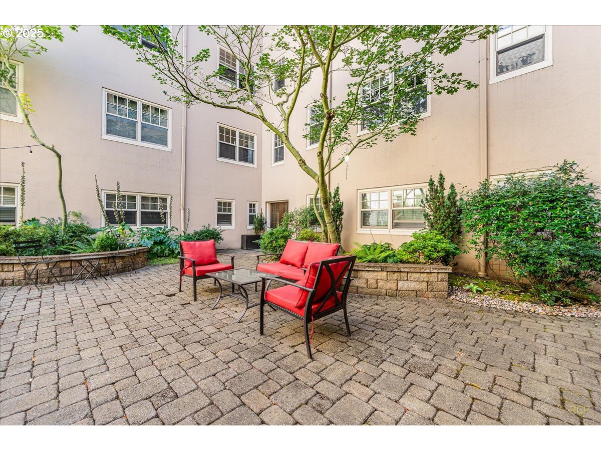 2015 Northwest Flanders Street, Unit 408 Portland, OR 97209 - Photo 23 of 37 a building outdoor space with patio furniture and potted plants