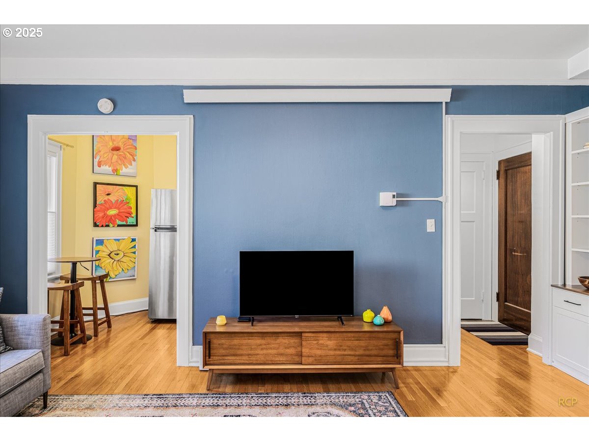 2015 Northwest Flanders Street, Unit 408 Portland, OR 97209 - Photo 3 of 37 a living room with furniture and a flat screen tv