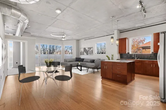 a kitchen with stainless steel appliances granite countertop a sink a stove and a refrigerator