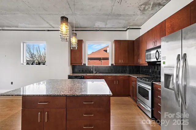 a kitchen with a sink cabinets and wooden floor