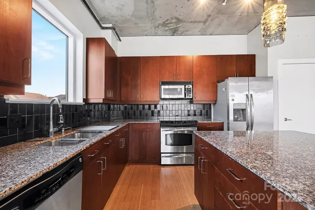 an empty room with windows cabinet and flat screen tv
