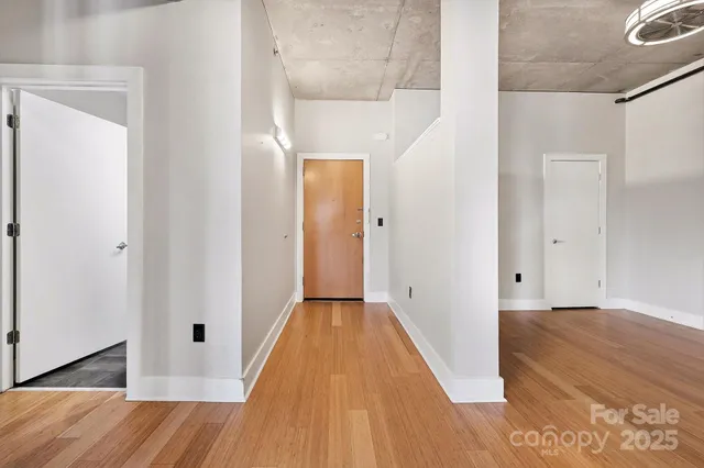a view of an empty room with wooden floor