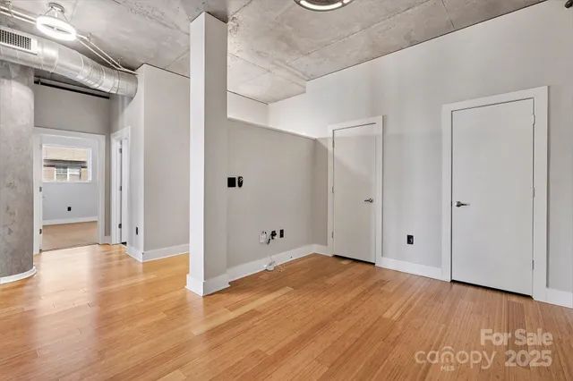 a view of a room with wooden floor