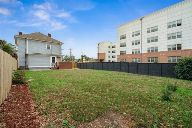 a back yard with tall buildings