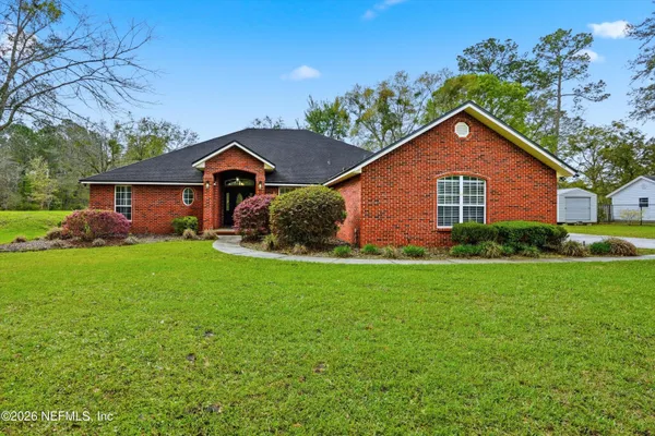 a front view of house with yard and green space