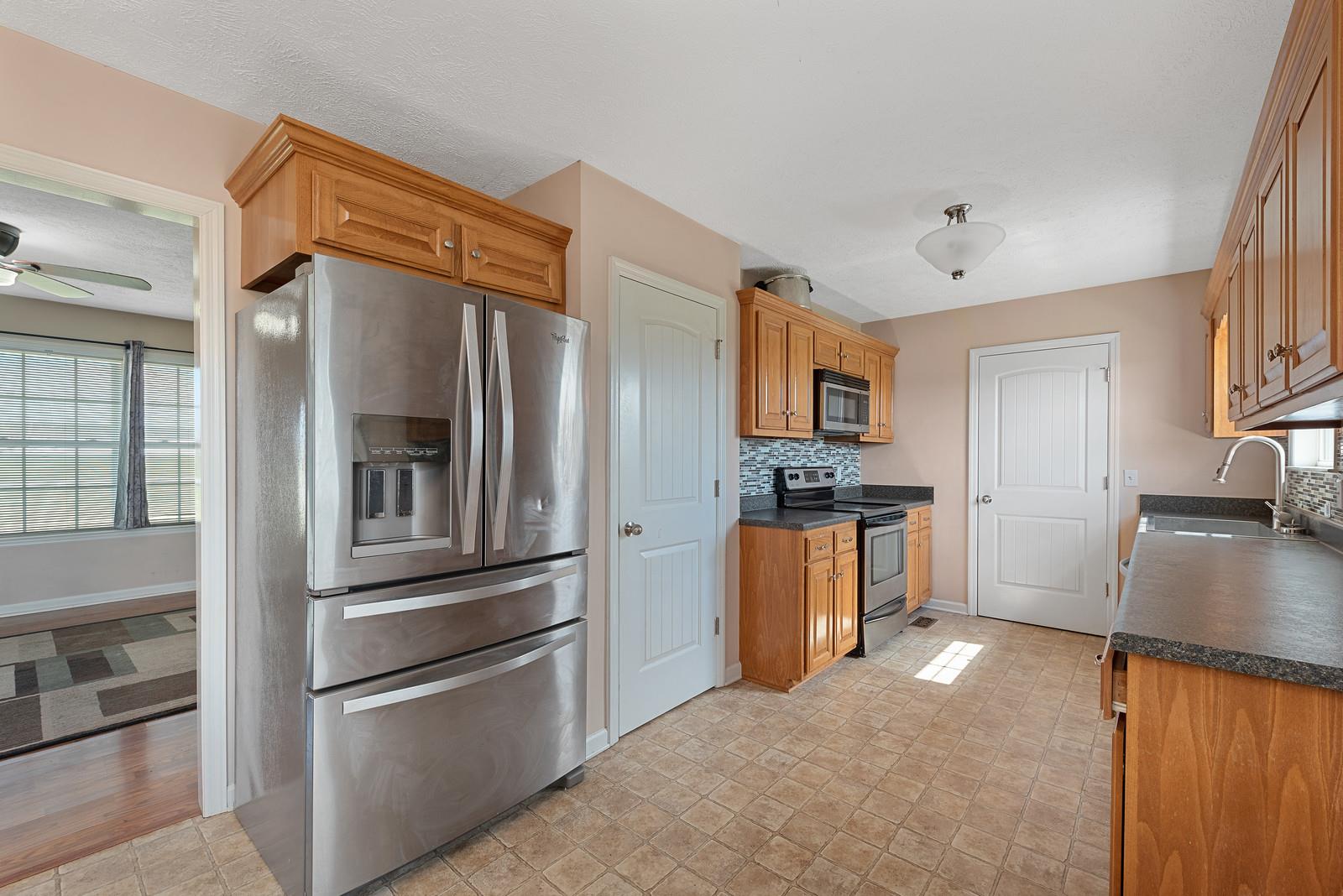 109 Spry Road Morrison, TN 37357 - Photo 14 of 30 a kitchen with stainless steel appliances granite countertop a refrigerator and a stove top oven