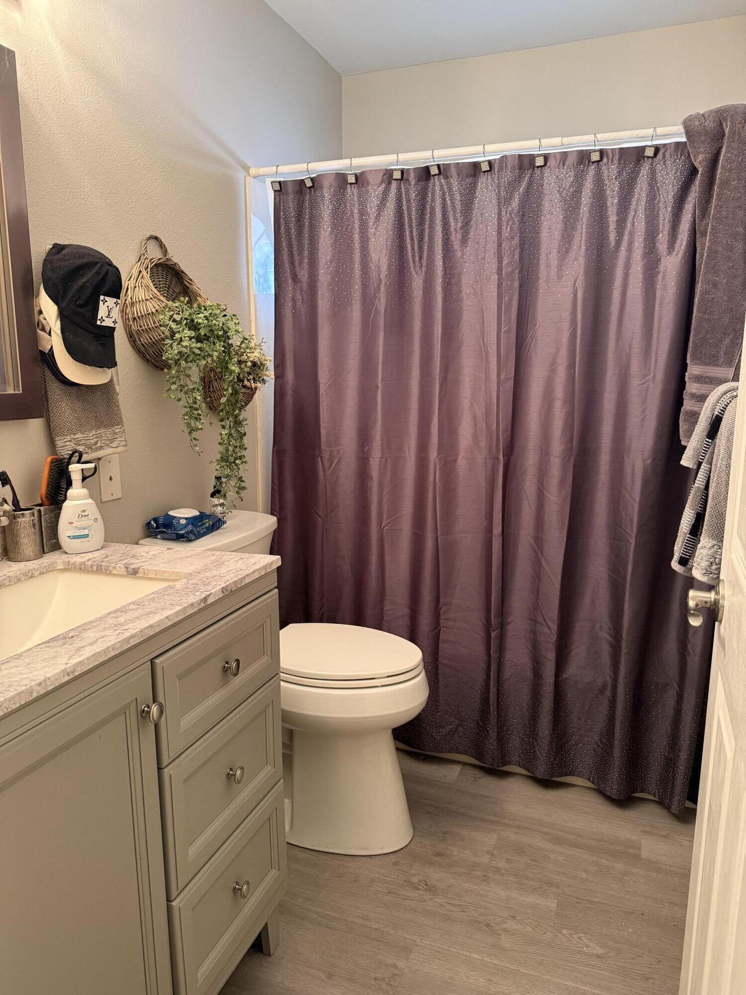 3863 Indian Trail, Unit 106 Destin, FL 32541 - Photo 18 of 22 a bathroom with a sink a toilet and shower curtain