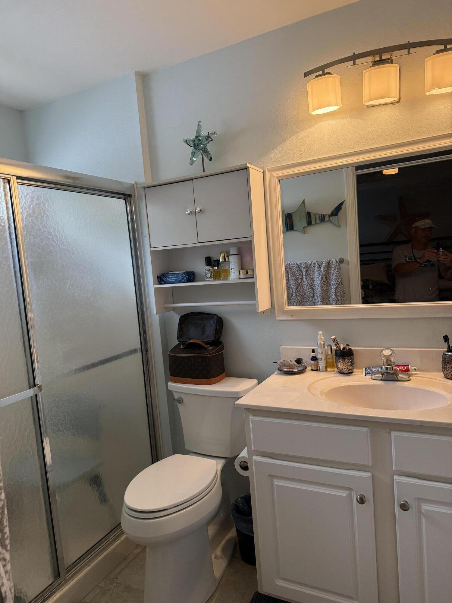 3863 Indian Trail, Unit 106 Destin, FL 32541 - Photo 20 of 22 a bathroom with a sink toilet and mirror