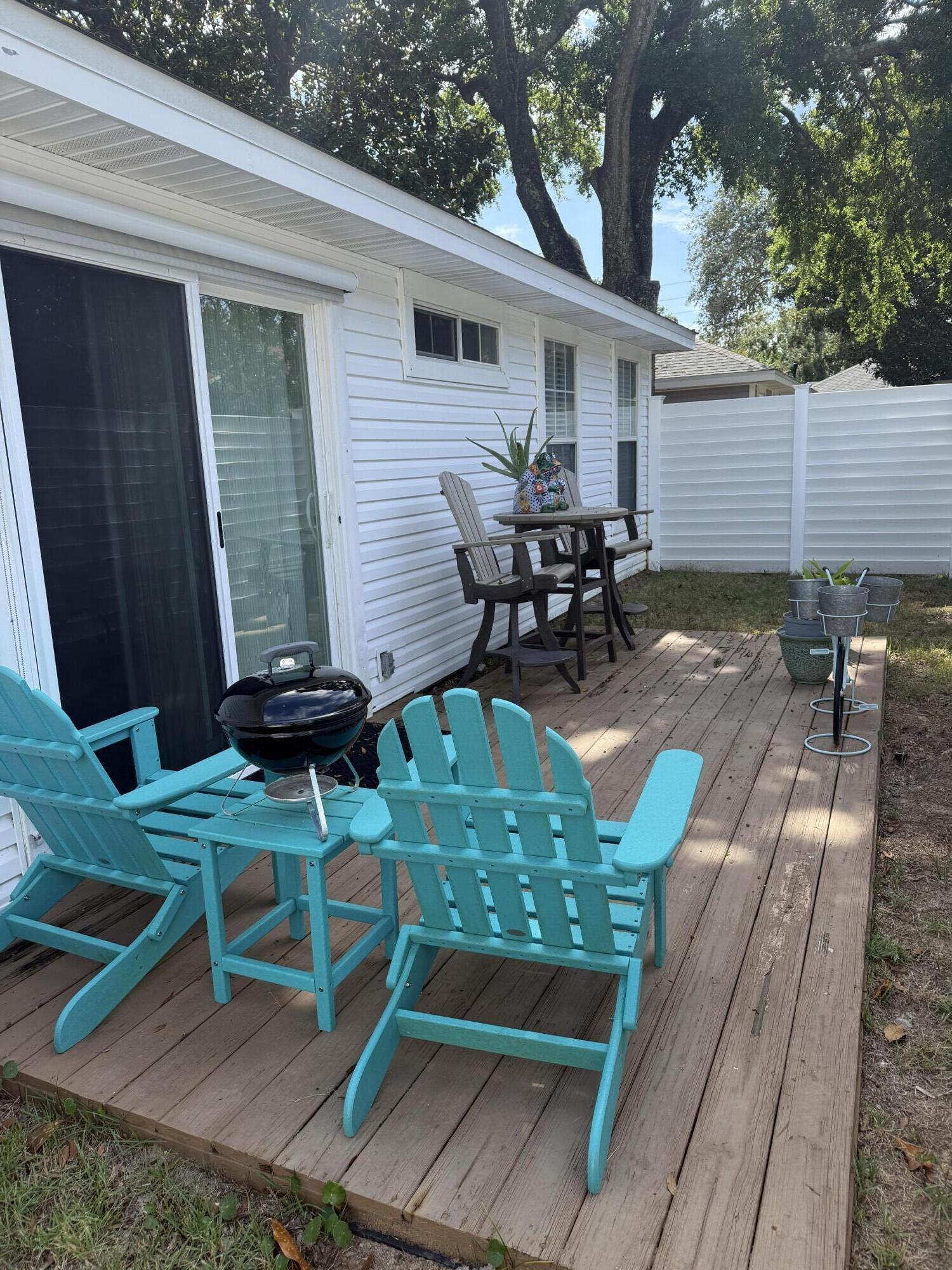 3863 Indian Trail, Unit 106 Destin, FL 32541 - Photo 22 of 22 a view of a chairs and table in patio