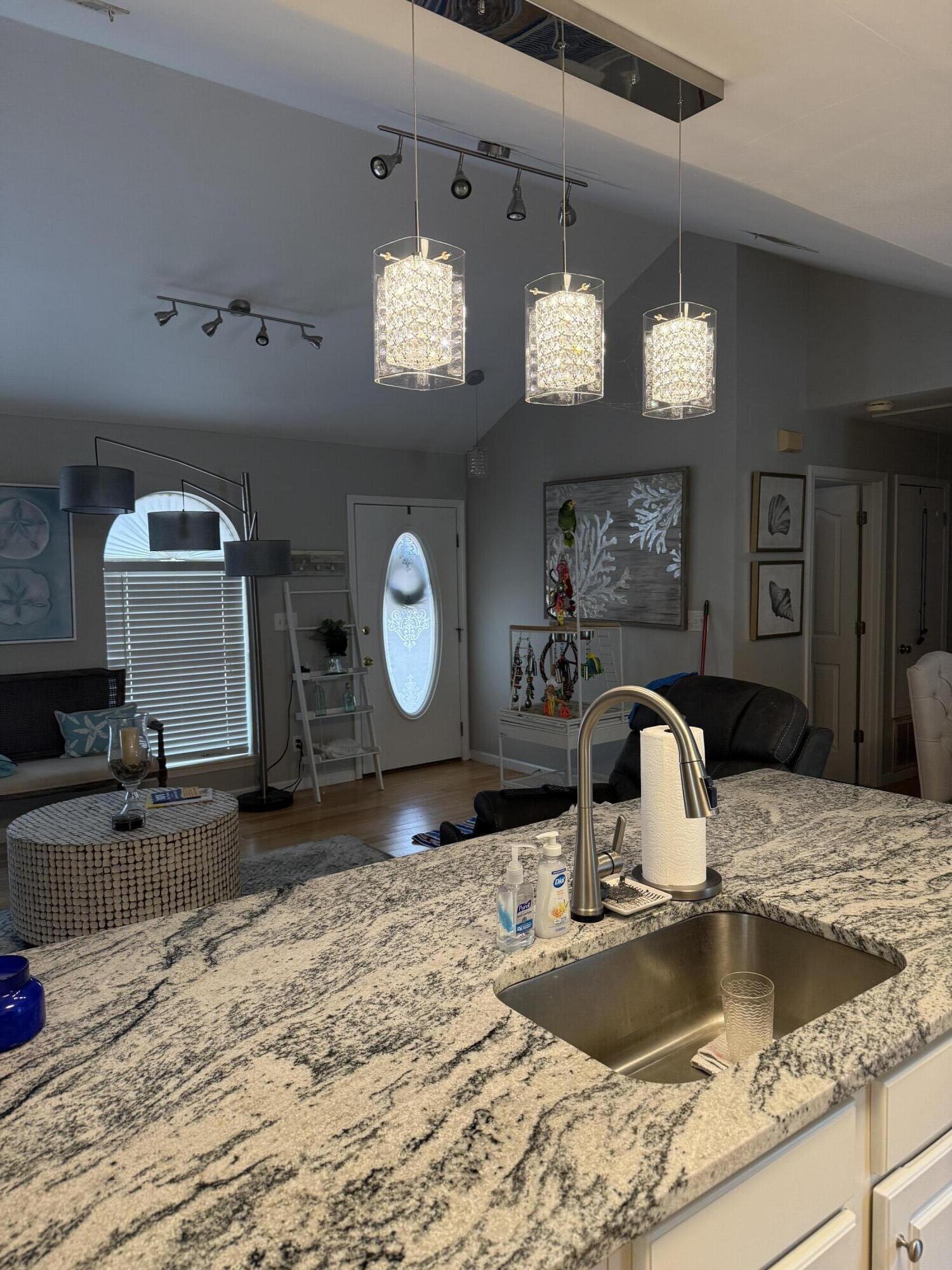 3863 Indian Trail, Unit 106 Destin, FL 32541 - Photo 7 of 22 a kitchen with a refrigerator a sink dishwasher a dining table and chairs with wooden floor