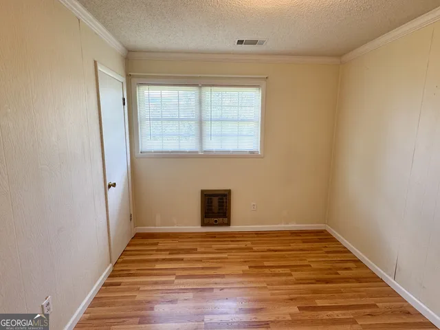 a view of a livingroom with wooden floor and a window