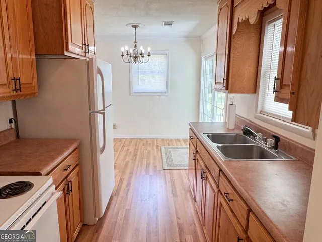 a kitchen with sink cabinets and wooden floor