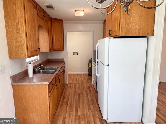 a kitchen with a refrigerator and a sink