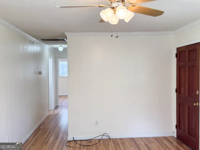 a view of a room with wooden floor