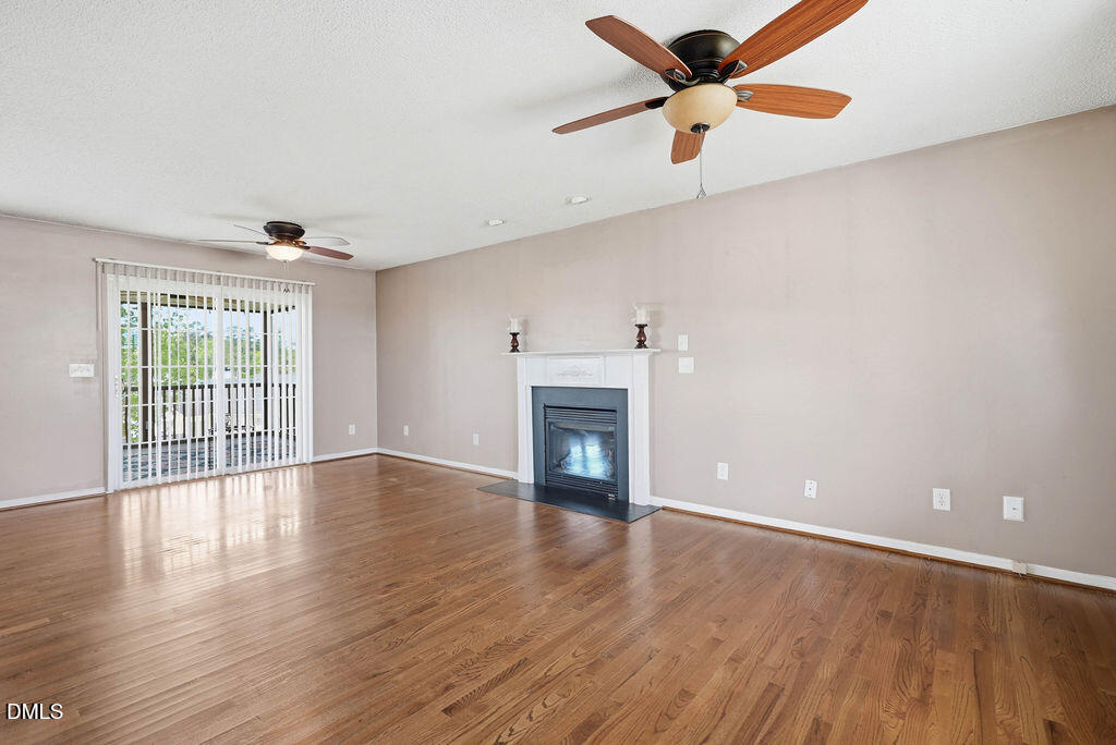 1560 Cane Mill Road Coats, NC 27521 - Photo 10 of 32 wooden floor in an empty room with a window