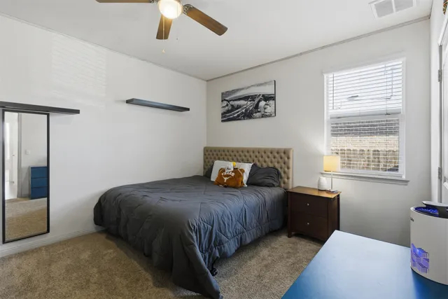 a bedroom with a bed and a window