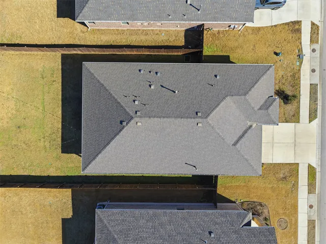 a view of swimming pool with outdoor seating and house in the background