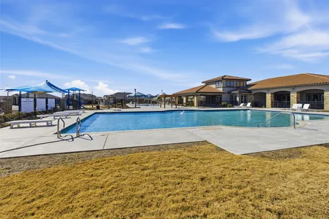 a view of a swimming pool with a lounge chairs