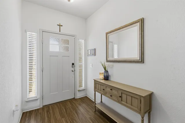 a view of a hallway view with wooden floor and staircase