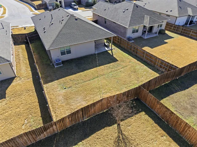 an aerial view of residential houses with outdoor space