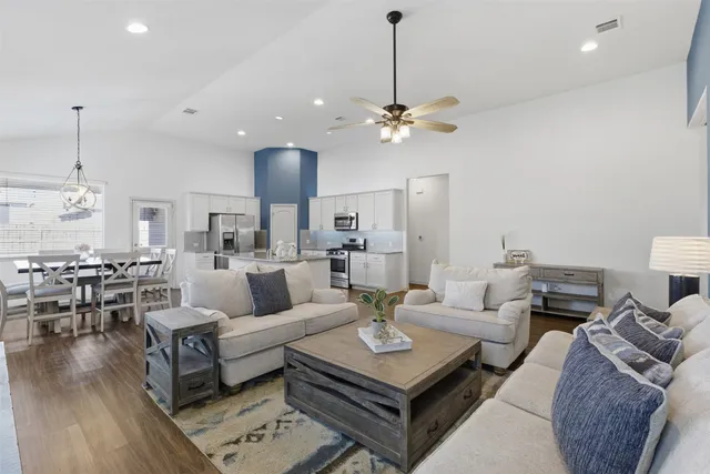 a large kitchen with stainless steel appliances granite countertop a lot of counter space and a sink