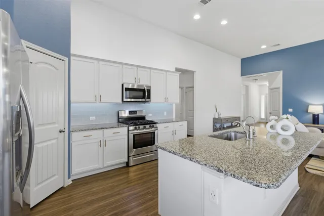 a kitchen with center island table and chairs