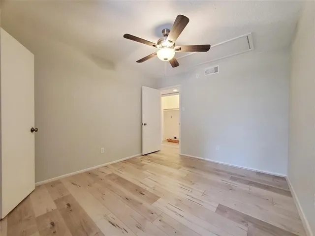 a view of a livingroom with a ceiling fan and window