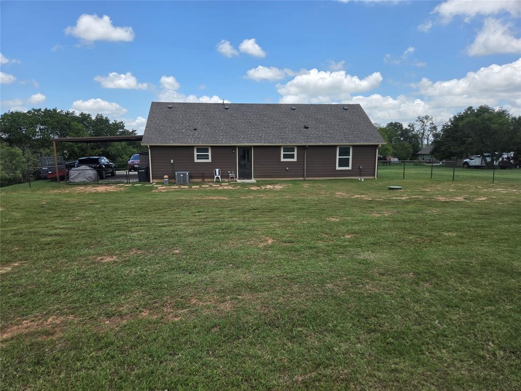 511 Erwin Road Poolville, TX 76487 - Photo 27 of 36 View of the back of house from large fenced in backyard