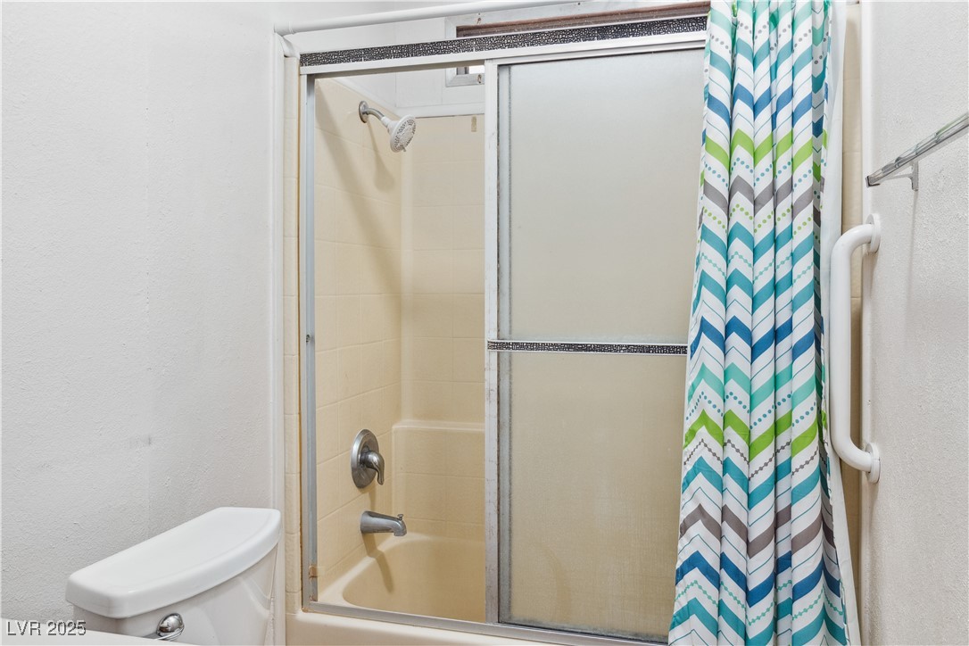 1671 Granada Street Laughlin, NV 89029 - Photo 19 of 63 Bathroom featuring combined bath / shower with glass door and toilet