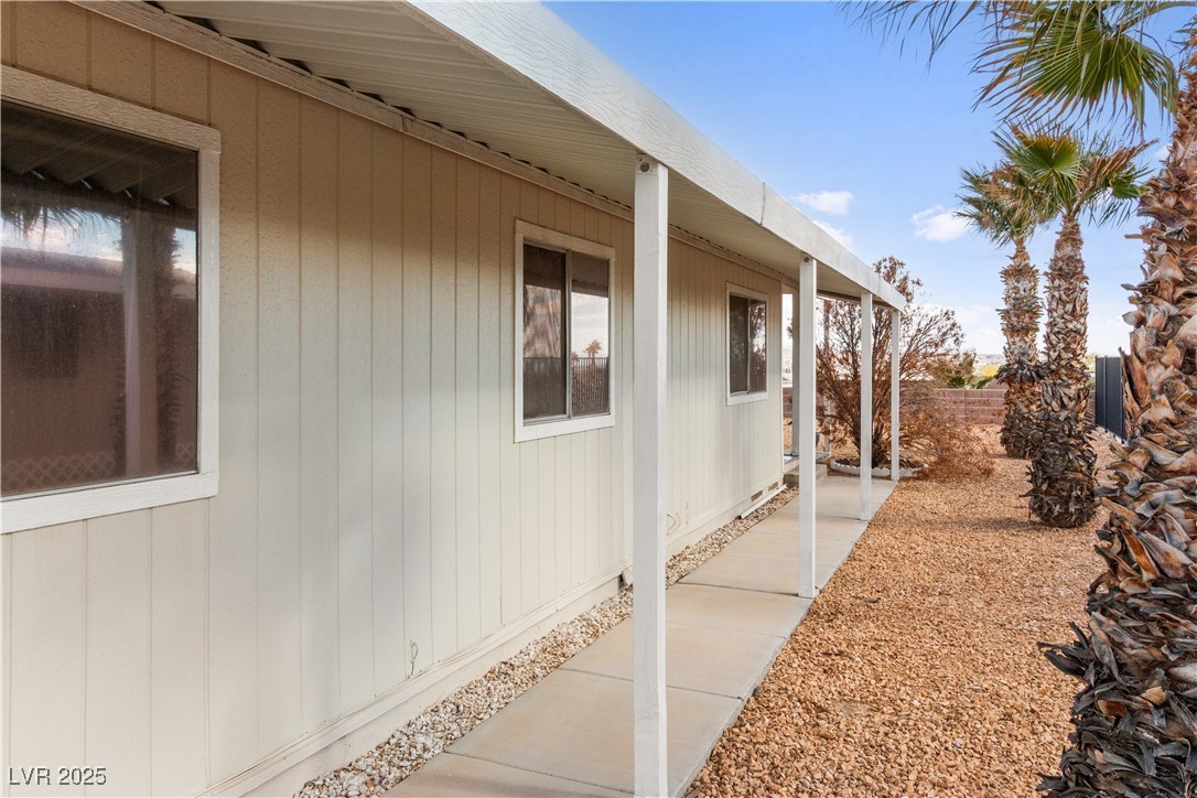 1671 Granada Street Laughlin, NV 89029 - Photo 3 of 63 View of side of home featuring fence