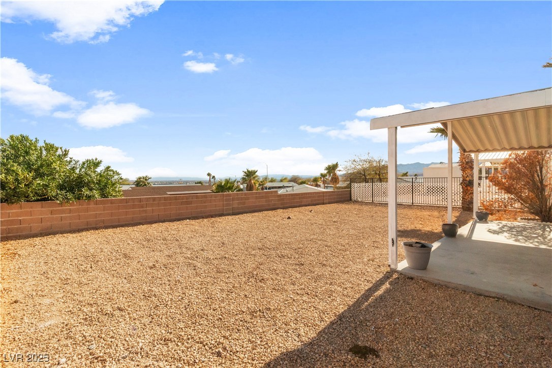 1671 Granada Street Laughlin, NV 89029 - Photo 36 of 63 View of yard with a fenced backyard and a patio