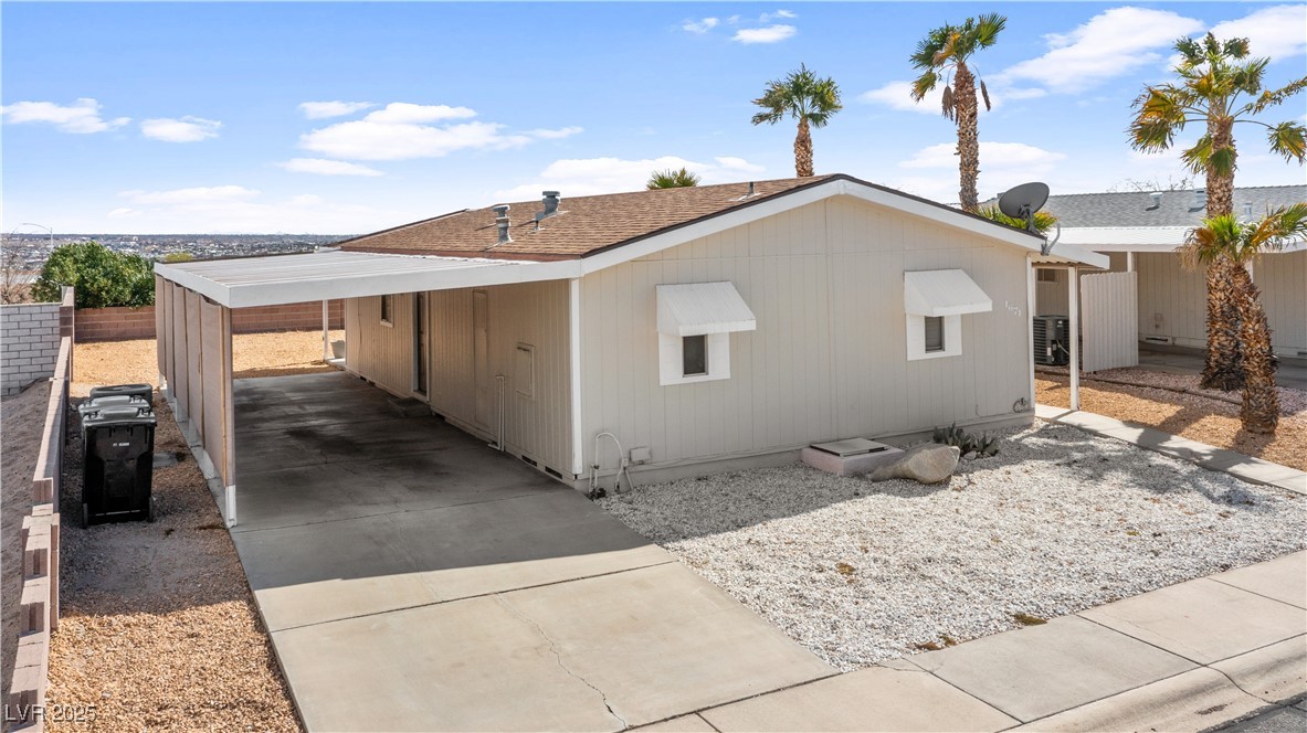 1671 Granada Street Laughlin, NV 89029 - Photo 61 of 63 View of side of property with concrete driveway, a carport, and cooling unit