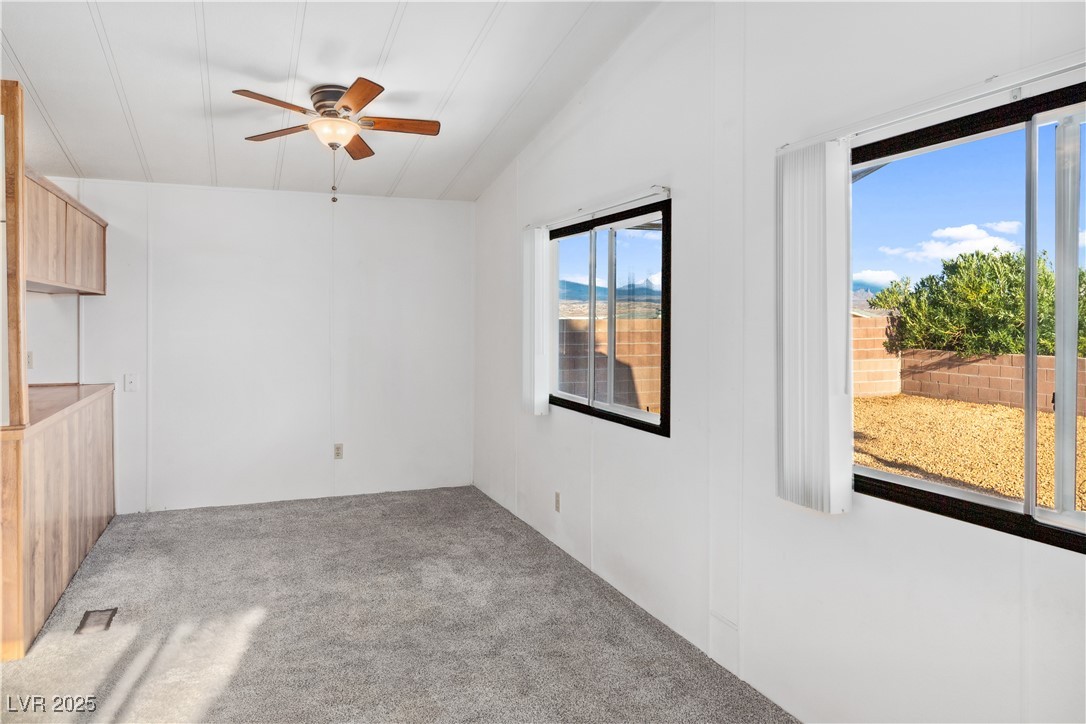 1671 Granada Street Laughlin, NV 89029 - Photo 9 of 63 Carpeted living room with a ceiling fan, visible vents, and vaulted ceiling