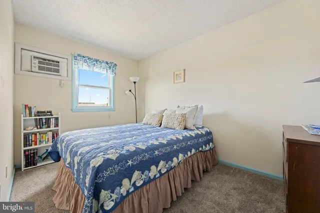 a bedroom with a bed next to a window and a book shelf