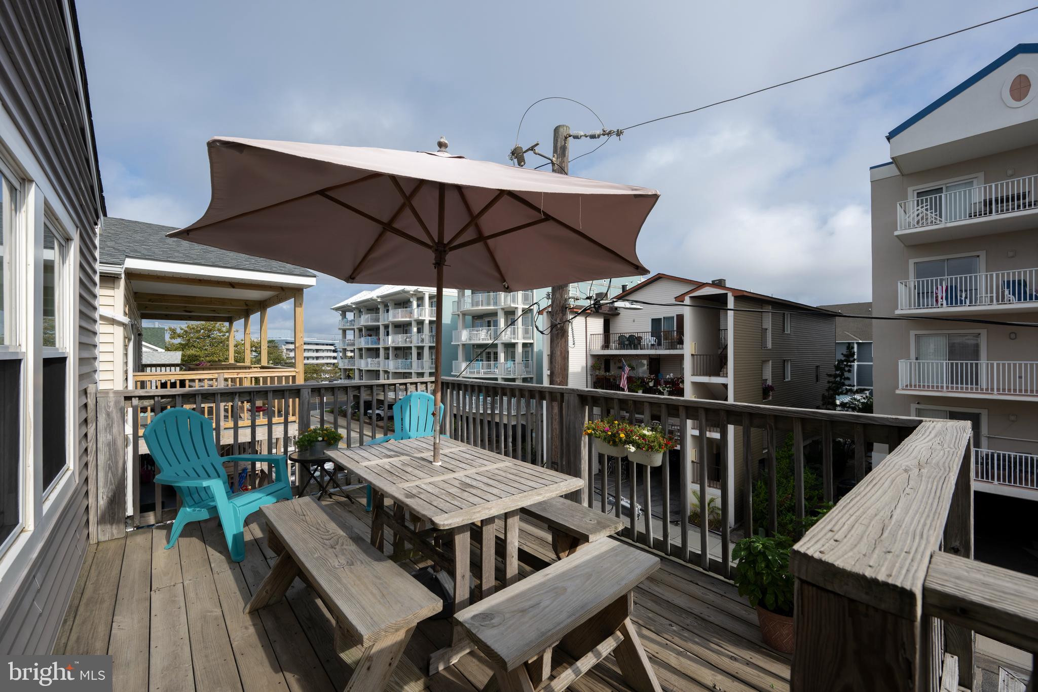 9 79th Street, Unit 3W Ocean City, MD 21842 - Photo 18 of 34 a view of a chairs and table on the deck